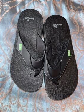 Sanuk Black Textured Foam Flip Flops with Green Tags